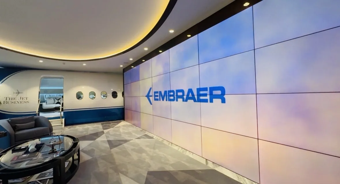 Inside The Jet Business showroom at Hyde Park Corner: full-scale cabin section beside the Embraer video wall